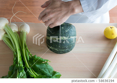 In front of the board to prepare vegetables 58636194