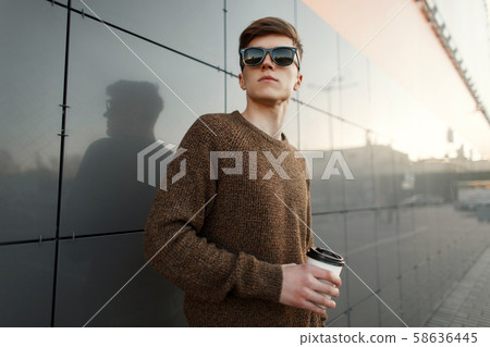 Young handsome man with coffee in sunglasses 58636445