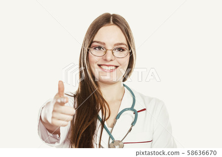 Woman doctor with stethoscope pointing at you. Woman doctor with stethoscope pointing at you. 58636670