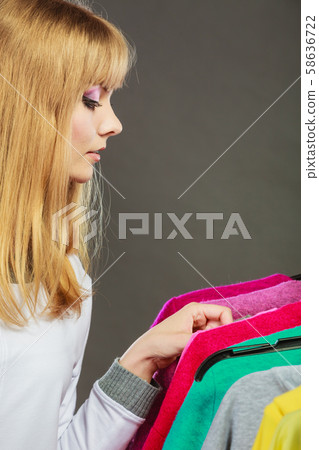 Pretty girl watching new clothes. 58636722