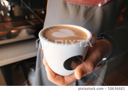 Stylish black espresso making machine, shooted in cafe. Close-up shot of barista hands Stylish black espresso making machine, shooted in cafe. Close-up shot of barista hands 58636881