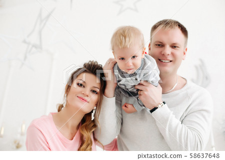 Couple with little son standing and posing in 58637648