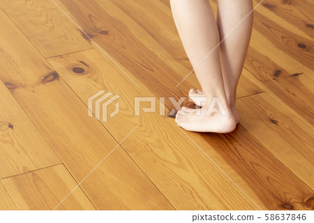Wood floor and young woman's feet up 58637846