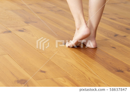 Wood floor and young woman's feet up Wood floor and young woman's feet up 58637847