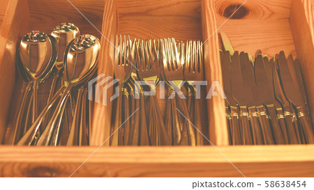 Spoons, forks, knives in the tray. Wooden drawer with modern cutlery. Kitchen or restaurant concept 58638454