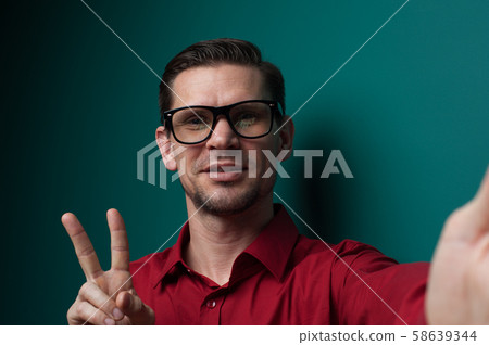 Portrait of a positive young man in glasses Portrait of a positive young man in glasses 58639344