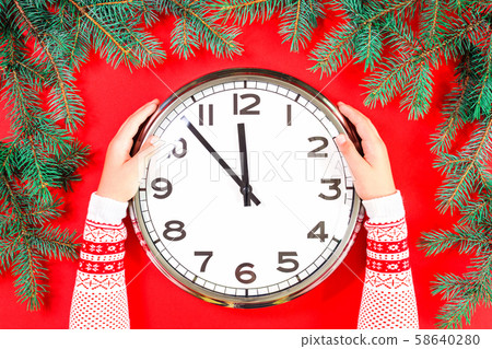 Christmas or New Year clock decor at midnight on red 58640280