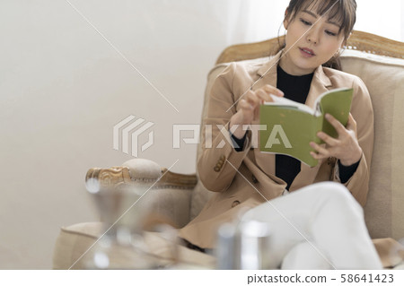 A young woman living alone while enjoying reading in a stylish room reborn through renovation 58641423