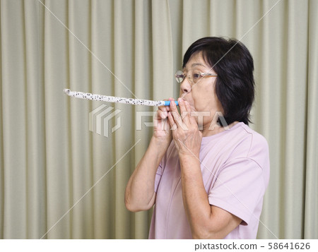 Senior woman blowing back 58641626