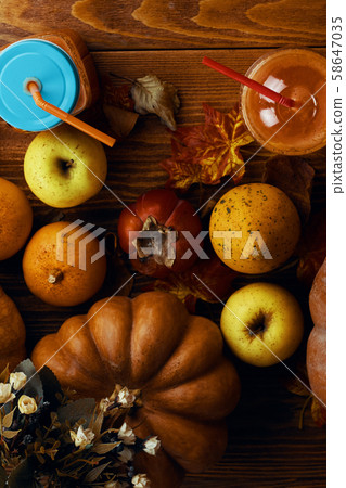 Pumpkins juice in bottles with pumpkins. 58647035