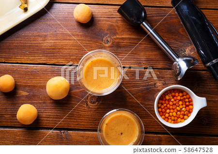 blender  laying at wooden table with fresh fruit 58647528