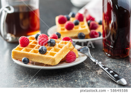 Waffles with blueberries and raspberries. 58649386
