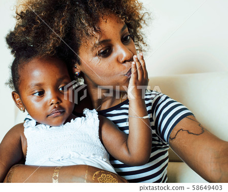 adorable sweet young afro-american mother with cute little daughter, hanging at home, having fun 58649403