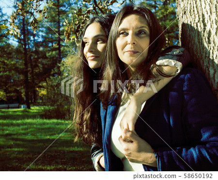 mature real mother with daughter outside autumn fall in park 58650192