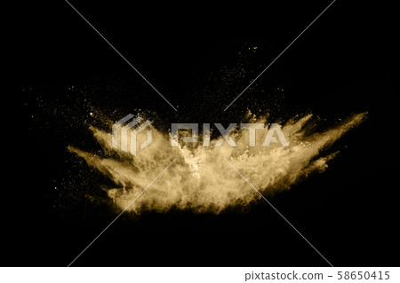 Golden powder explosion on black background.  58650415