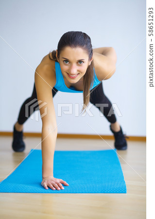Young woman practicing yoga, doing Wild Thing, Flip-the-Dog exercise, Camatkarasana pose, working 58651293