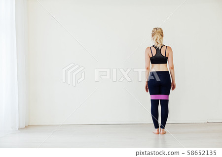 Female athlete squats with fitness gum sports Female athlete squats with fitness gum sports 58652135
