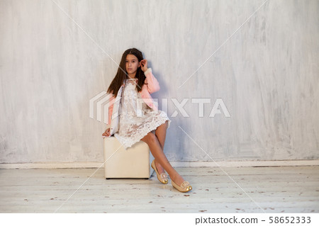 Portrait of a beautiful brunette girl in pink clothes 58652333