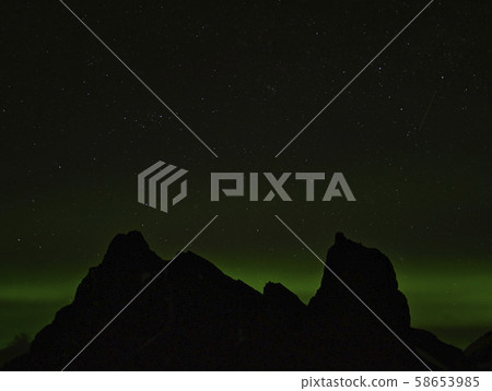 Aurora Borealis in Iceland behind the mountains 58653985