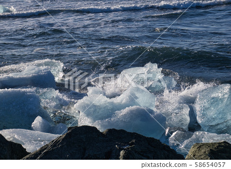 Drifting glacier parts on the coast of Iceland 58654057