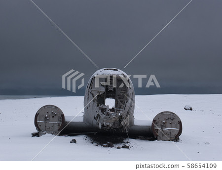 Aircraft wreck in Iceland on snow-covered meadow Aircraft wreck in Iceland on snow-covered meadow 58654109