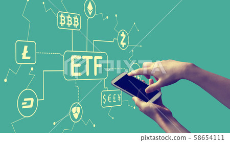 Cryptocurrency ETF theme with person holding smartphone Cryptocurrency ETF theme with person holding smartphone 58654111
