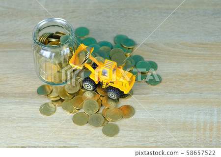Mini bulldozer truck loading stack coin with pile Mini bulldozer truck loading stack coin with pile 58657522