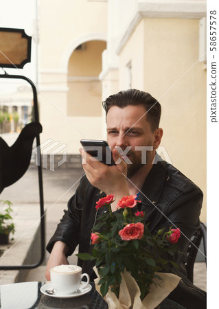 Trendy man on summer terrace cafe with smartphone Trendy man on summer terrace cafe with smartphone 58657578