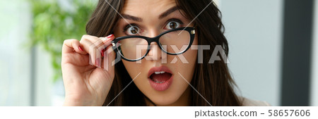 Young beautiful business woman holding glasses 58657606