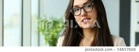 Beautiful smiling girl at workplace look in camera portrait Beautiful smiling girl at workplace look in camera portrait 58657608