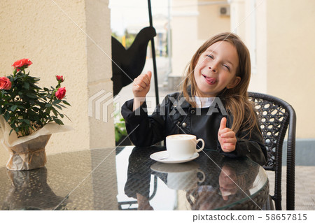 Schoolchild on terrace of summer cafe 58657815