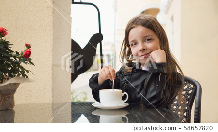 Schoolchild on terrace of summer cafe 58657820
