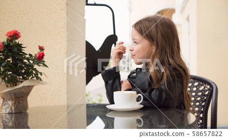 Schoolchild on terrace of summer cafe Schoolchild on terrace of summer cafe 58657822