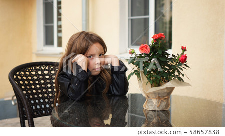 Schoolchild on terrace of summer cafe 58657838