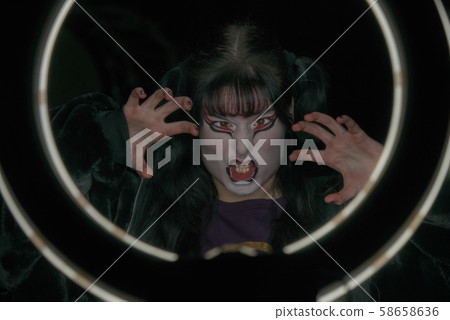 Girl with a make-up in the form of a witch or a 58658636