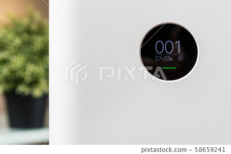 Closeup front view of Air purifier monitor screen that show air quality in the room is very safe and clean while dust air pollution situation outside is really bad. PM 2.5, Air quality index 58659241