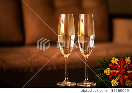 Glasses filled with champagne on Christmas background 58660039