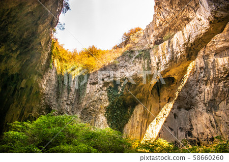 View inside the Devetashka Cave near Devetaki village and Osam river in Lovech, Bulgaria. Natural wonder. One of the largest karst cave in Eastern Europe, now home to near 30000 bats View inside the Devetashka Cave near Devetaki village and Osam river in Lovech, Bulgaria. Natural wonder. One of the largest karst cave in Eastern Europe, now home to near 30000 bats 58660260