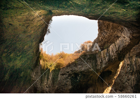 View inside the Devetashka Cave near Devetaki village and Osam river in Lovech, Bulgaria. Natural wonder. One of the largest karst cave in Eastern Europe, now home to near 30000 bats 58660261