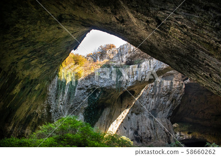 View inside the Devetashka Cave near Devetaki village and Osam river in Lovech, Bulgaria. Natural wonder. One of the largest karst cave in Eastern Europe, now home to near 30000 bats View inside the Devetashka Cave near Devetaki village and Osam river in Lovech, Bulgaria. Natural wonder. One of the largest karst cave in Eastern Europe, now home to near 30000 bats 58660262