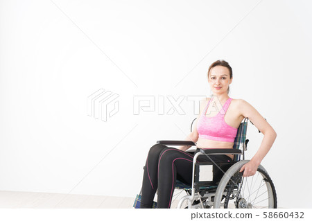 A foreign woman who wears sportswear and rides in a wheelchair A foreign woman who wears sportswear and rides in a wheelchair 58660432