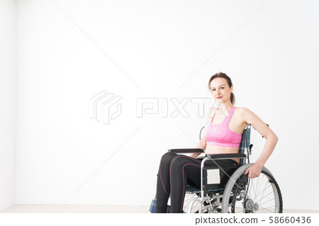 A foreign woman who wears sportswear and rides in a wheelchair A foreign woman who wears sportswear and rides in a wheelchair 58660436