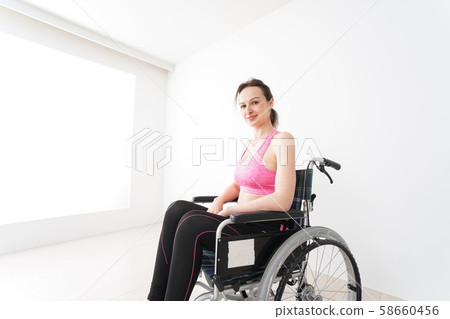 A foreign woman who wears sportswear and rides in a wheelchair A foreign woman who wears sportswear and rides in a wheelchair 58660456
