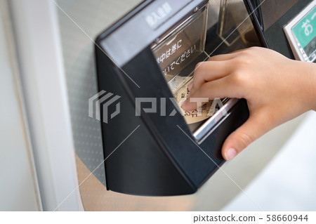Japan, Tokyo - August 30 2019: Hand of a child take the Gondola sky shuttle ticket from the ticket machine to ride to the amusement park. Japanese, urban lifestyle, Automatic, Payment, Purchasing. Japan, Tokyo - August 30 2019: Hand of a child take the Gondola sky shuttle ticket from the ticket machine to ride to the amusement park. Japanese, urban lifestyle, Automatic, Payment, Purchasing. 58660944