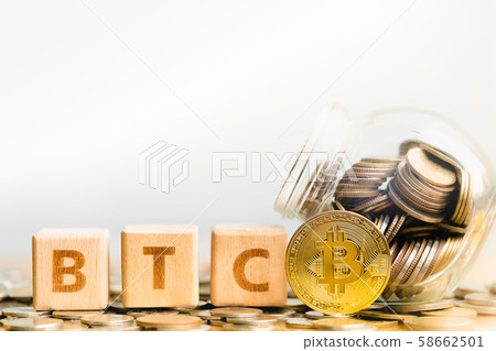 Bitcoin(BTC) Coins and Wood block word BTC.  58662501