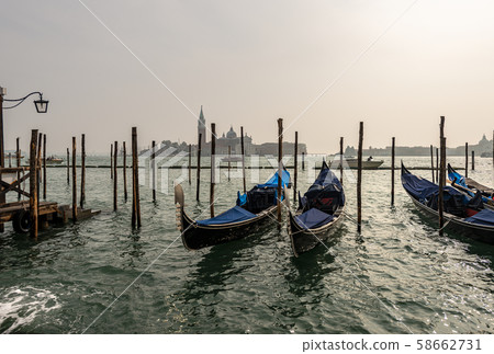 Venice Italy - Gondolas in lagoon and island of San Giorgio Maggiore Venice Italy - Gondolas in lagoon and island of San Giorgio Maggiore 58662731