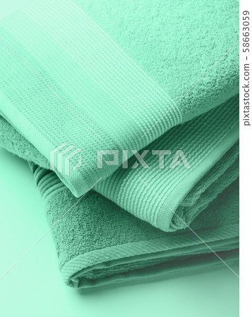 Pastel color clean folded towels. Mint green Pastel color clean folded towels. Mint green 58663059