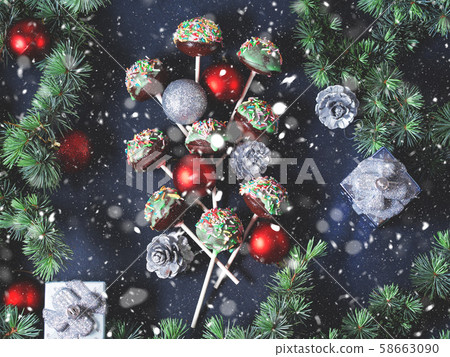 Christmas tree branches with cake pops and baubles 58663090