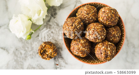 Energy balls with healthy ingredients on marble 58663099