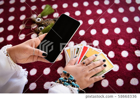 Fortune teller reading fortune lines on screen 58668336